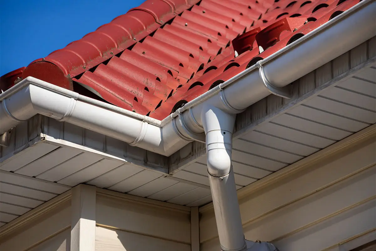 Building Modern House Construction with metal roof corner, rain gutter system and roof protection from snow board, snow bar Snow guard.