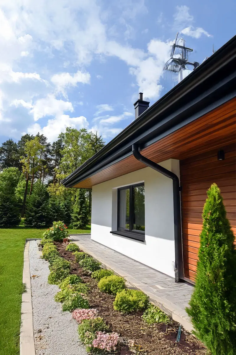 Modern home showcasing seamless aluminum rain gutters on its façade.